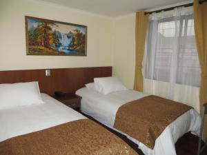 Ein Bett oder Betten in einem Zimmer der Unterkunft Hotel Newen