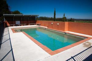 a swimming pool on top of a house at Adina Vineyard in Lovedale