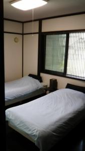 Guest House Koundo tesisinde bir odada yatak veya yataklar