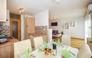 a kitchen and a dining room with a table at Apartment Skyscraper Maro in Rijeka
