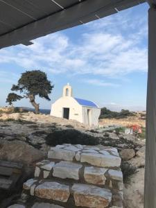 a small white church on top of a hill at Anatoli in Ambelas