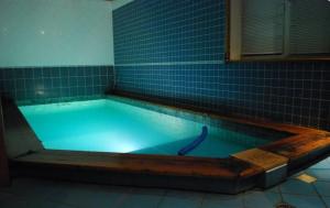 a large swimming pool with a wooden frame around it at Bebru pirts in Vecbebri