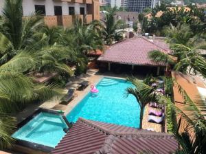 an overhead view of a swimming pool with palm trees at Cocco Resort in Pattaya South