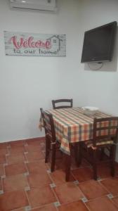 トラーパニにあるTrapani Centro Little Homeのテーブル(椅子2脚付)、壁掛けテレビ