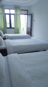 Giường trong phòng chung tại Cong Doan Gia Lai Hotel