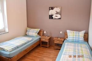 a bedroom with two beds and two night stands at Ferienweingut Borens in Wiltingen
