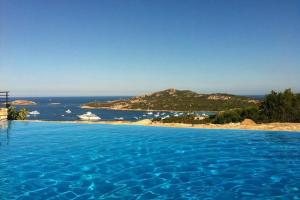 a large swimming pool with a view of the ocean at Paradiso in Costa Smeralda in Porto Cervo