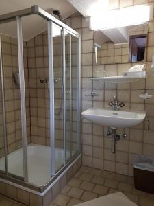 a bathroom with a shower and a sink at Sporthotel Pechtl in Lermoos