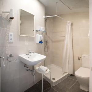 a bathroom with a sink and a shower and a toilet at L´Hostalet in Tossa de Mar