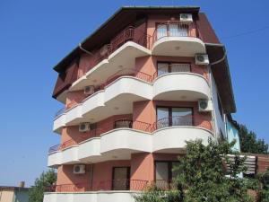 a tall red building with balconies at House Sofia in Sveti Vlas
