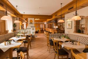 a restaurant with tables and chairs in a room at Hotel & Gasthof Richard Held in Regensburg