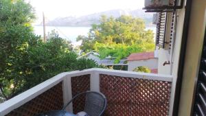 a balcony with a table and chairs and a view of the water at Apartments Andrea in Baška
