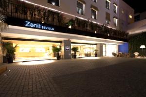 a store front of a building at night at Zenit Sevilla in Seville