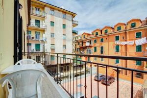 a balcony with a chair and some buildings at Casa Vacanze Oneglia in Imperia