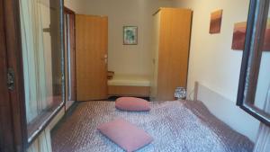 a bedroom with a bed with a pink pillow on it at Apartments Andrea in Baška
