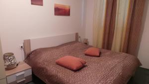 a bedroom with a bed with two pillows on it at Apartments Andrea in Baška