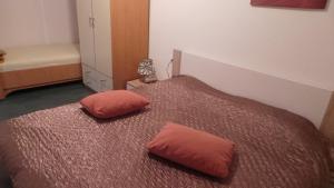 a bedroom with a bed with two pillows on it at Apartments Andrea in Baška