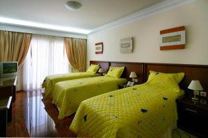 Postel nebo postele na pokoji v ubytování Porto Alegre Hotel