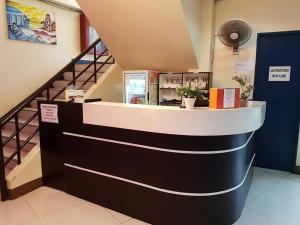 a counter in a store with a staircase at City Corner Hotel in Legazpi