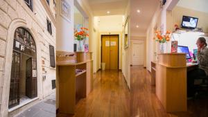 a corridor of a building with wooden counters and flowers at Hotel Martino Ai Monti in Rome