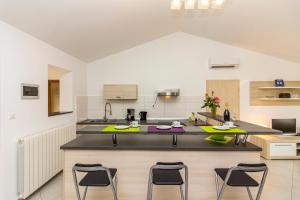 a kitchen with four chairs and a counter top at Apartment Ruby in Pula
