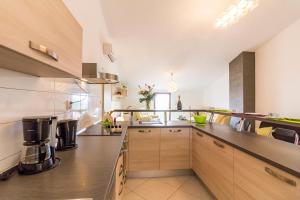 a large kitchen with stainless steel appliances and wooden cabinets at Apartment Ruby in Pula