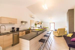 a kitchen with a counter and chairs in a room at Apartment Ruby in Pula +40 photos