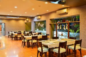 un restaurante con mesas y sillas en una habitación en Inventree hotels & Resort, en Pune