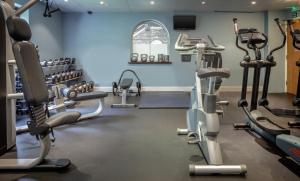 a gym with treadmills and elliptical machines at Oxford Witney Hotel in Witney