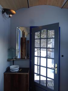 a bathroom with a door with a window and a sink at Evergrin in Gadmen