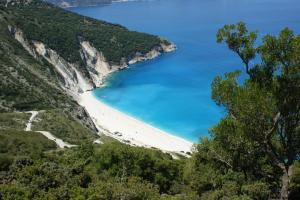 a beach on the side of a mountain at Myrtos View Apartments in Anomeriá