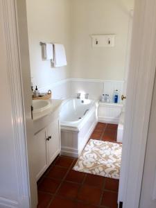 a bathroom with a tub and a sink at Southey House in Kloof