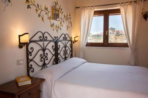 מיטה או מיטות בחדר ב-Casale Di Caterina