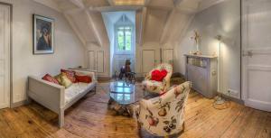 a living room with two couches and a glass table at Domaine des Papeteries in Plounevez-Moëdec