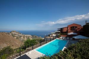a swimming pool with a view of the ocean at Casale Di Caterina in Taormina
