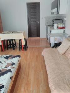 a living room with a couch and a table at Sea Apartment in Burgas