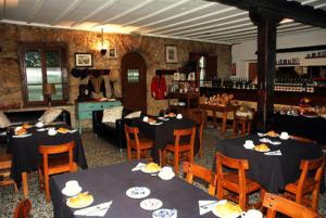 a dining room with tables and chairs and a restaurant at CR Luarri in San Sebastián