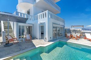 a villa with a swimming pool and a house at Cape Villa at Sounio in Sounio
