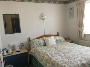 Ένα ή περισσότερα κρεβάτια σε δωμάτιο στο The Hotel Wilmar