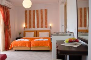 a bedroom with a bed and a bowl of fruit on a table at Palmyra Hotel in Nydri