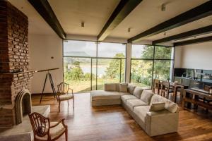 a living room with a couch and a fireplace at The Bungalow in Nuwara Eliya