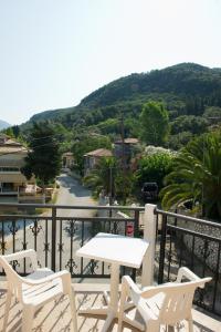 a table and chairs on a balcony with a view at Geroulis Stefanos Studios in Vasiliki