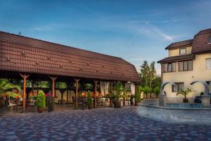 a building with a pavilion next to a building at Hotel Melody in Satu Mare