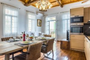 a kitchen and dining room with a table and chairs at Evagelia's deluxe villa-Jacuzzi in Skopelos center in Skopelos Town
