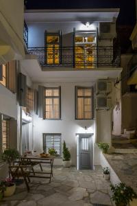 een gebouw met een tafel en een balkon bij EVAGELIA'S APPARTMENT in Skopelos Town
