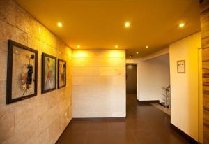 a hallway of a building with a yellow ceiling at Roots Apartment Hotel in Accra