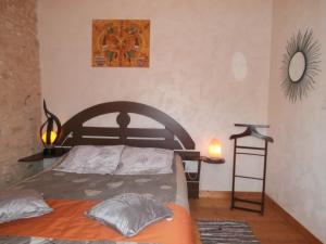 1 dormitorio con cama, espejo y estante en Au lézard doré, en Lamonzie-Montastruc