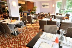 a dining room with tables and chairs in a restaurant at Azureva Pornichet Baie de La Baule in Pornichet