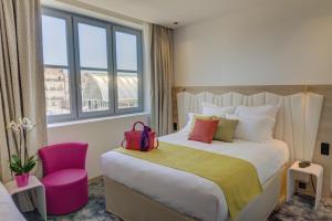 Ένα ή περισσότερα κρεβάτια σε δωμάτιο στο Best Western Plus Comedie Saint Roch
