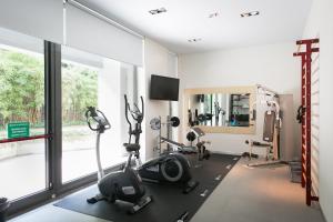 a room with a gym with bikes and a mirror at Zambala Luxury Apartments in Milan